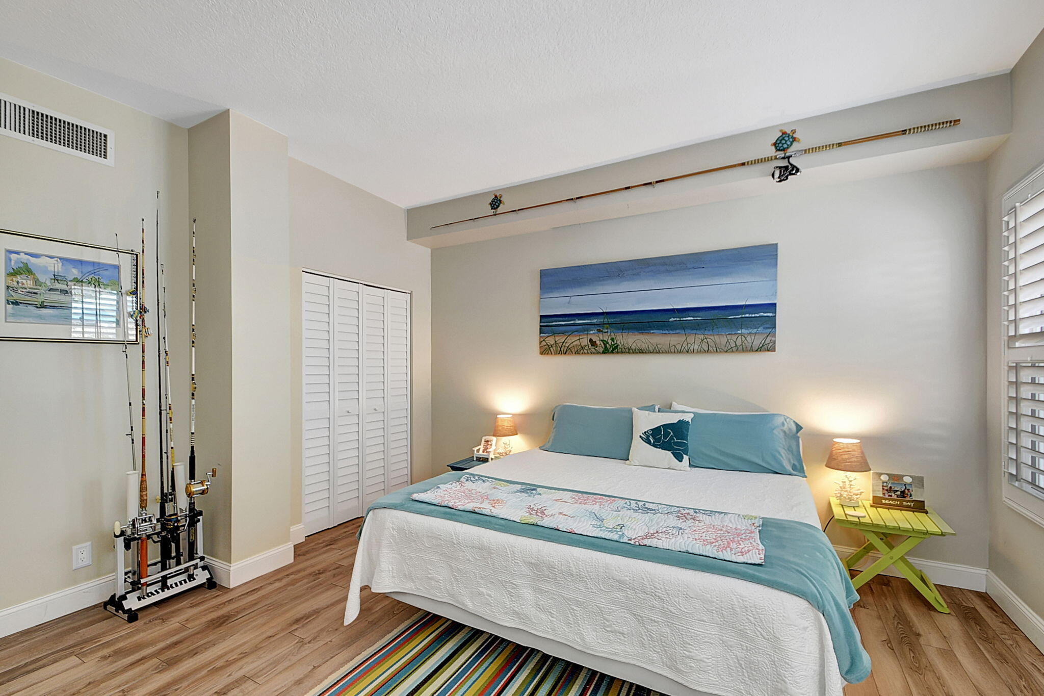 3230 South Ocean Boulevard, Unit C100 Palm Beach, FL 33480 - Photo 26 of 49 a bedroom with a bed and wooden floor