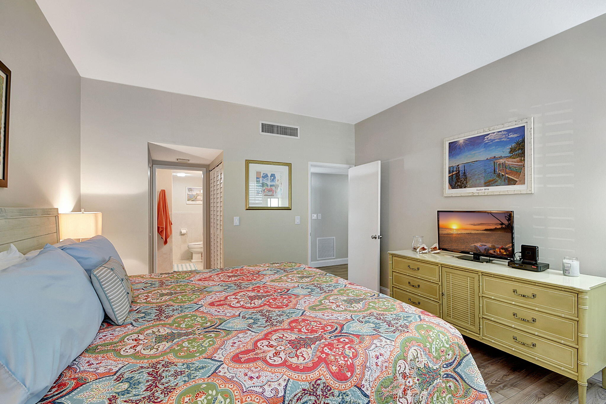 3230 South Ocean Boulevard, Unit C100 Palm Beach, FL 33480 - Photo 32 of 49 a bedroom with a bed and a flat screen tv