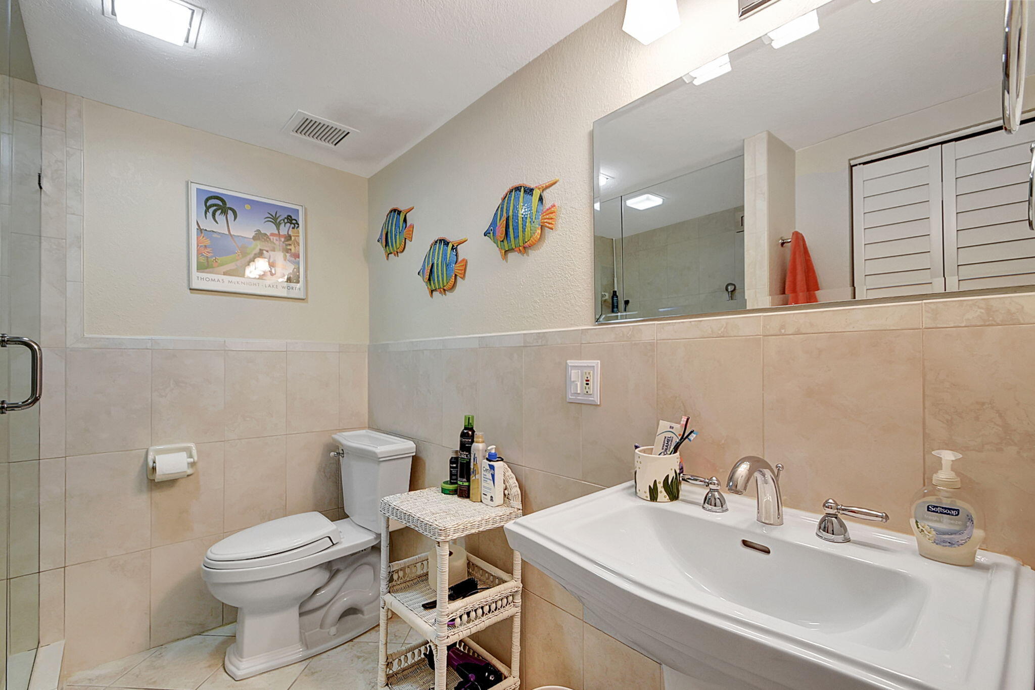 3230 South Ocean Boulevard, Unit C100 Palm Beach, FL 33480 - Photo 33 of 49 a bathroom with a toilet a sink and mirror