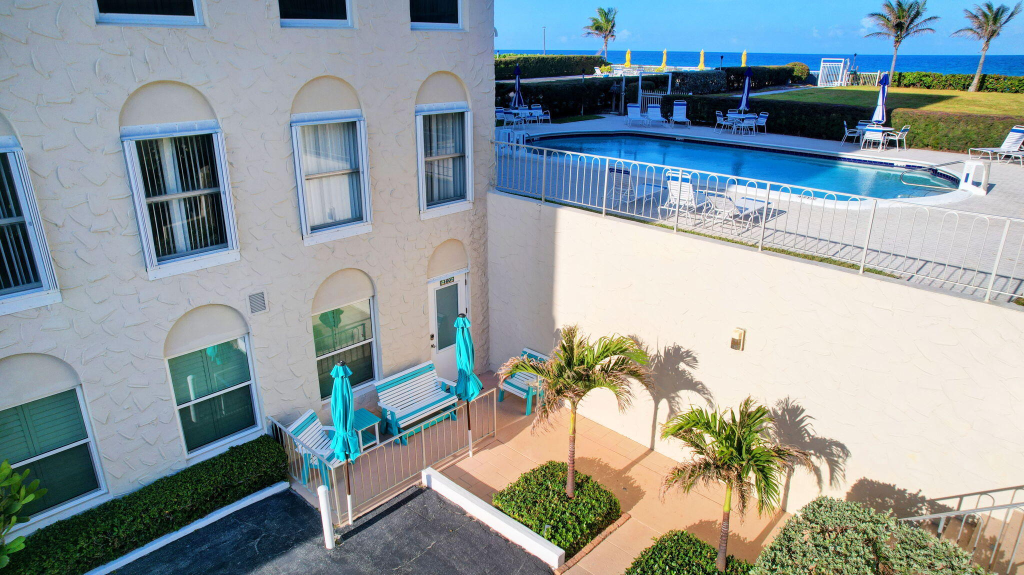 3230 South Ocean Boulevard, Unit C100 Palm Beach, FL 33480 - Photo 37 of 49 a view of a swimming pool with outdoor seating and plants