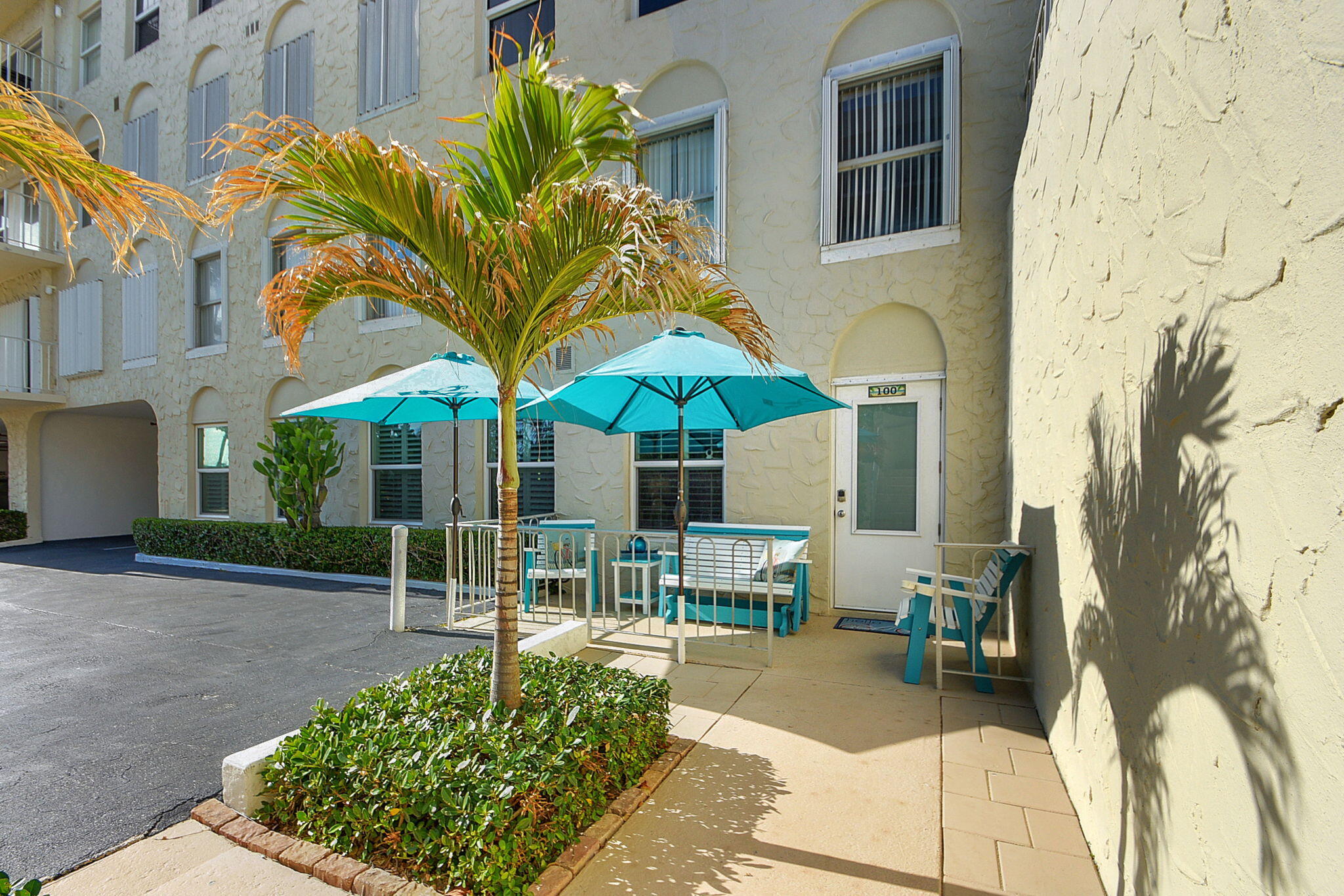 3230 South Ocean Boulevard, Unit C100 Palm Beach, FL 33480 - Photo 9 of 49 a backyard of a house with table and chairs