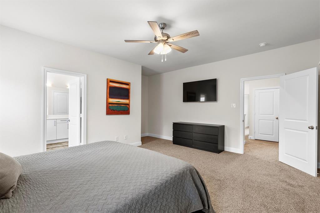 6329 Mason Court Dallas, TX 75227 - Photo 11 of 34 a bedroom with a bed and a flat screen tv