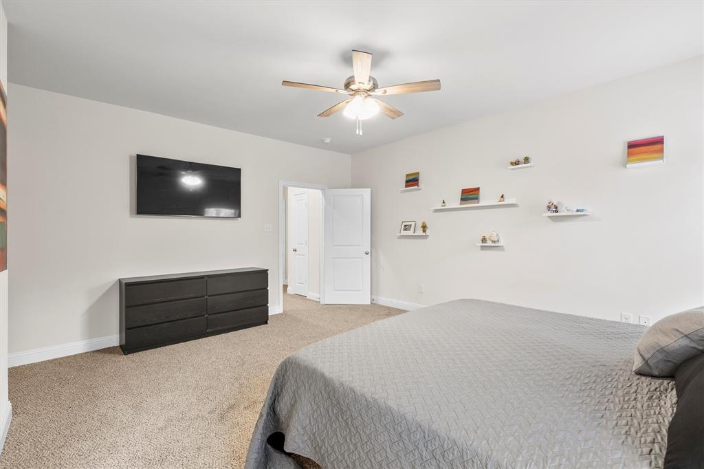 6329 Mason Court Dallas, TX 75227 - Photo 12 of 34 a bedroom with a bed and a flat screen tv