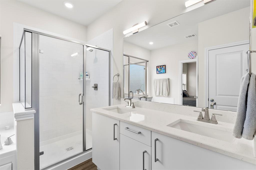 6329 Mason Court Dallas, TX 75227 - Photo 14 of 34 a bathroom with a double vanity sink mirror and shower