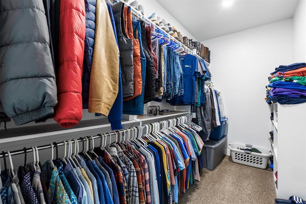 6329 Mason Court Dallas, TX 75227 - Photo 15 of 34 a view of walk in closet with clothes and shoes