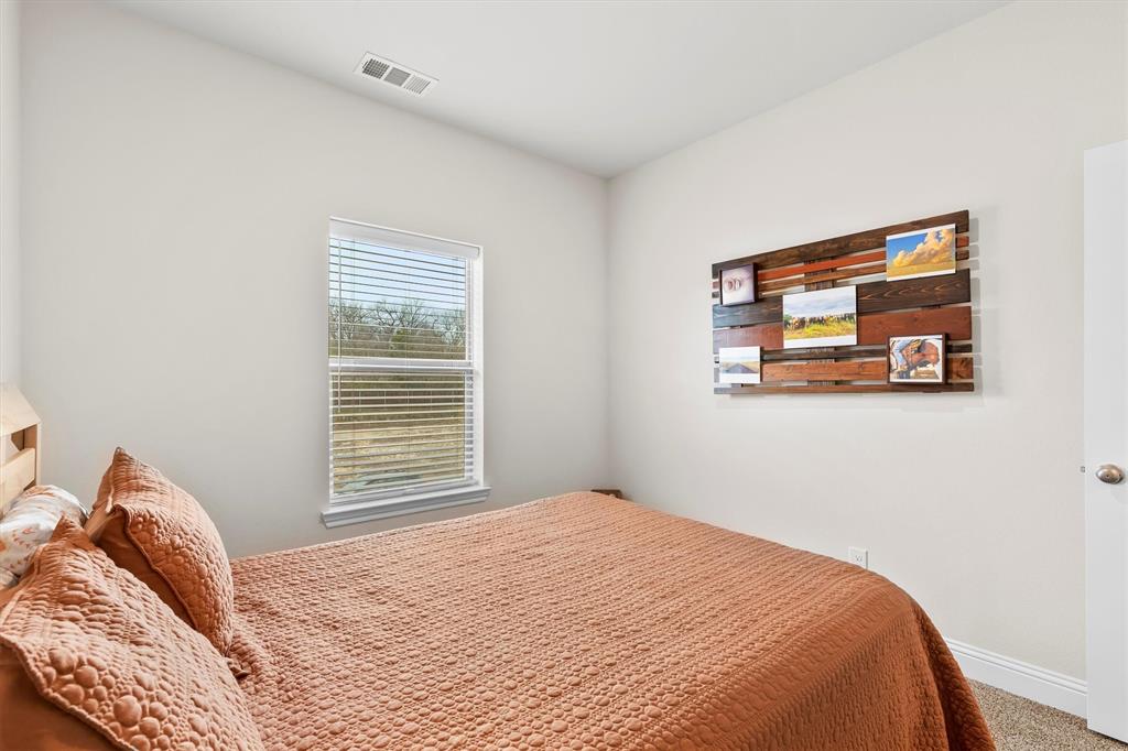 6329 Mason Court Dallas, TX 75227 - Photo 17 of 34 a bedroom with a bed and a window