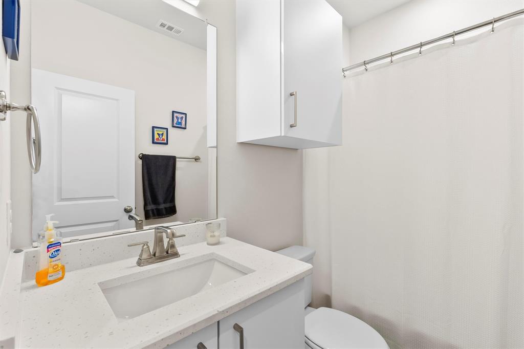 6329 Mason Court Dallas, TX 75227 - Photo 21 of 34 a bathroom with a sink toilet and vanity