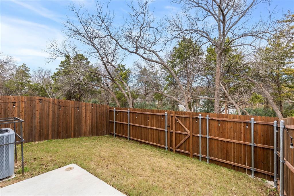 6329 Mason Court Dallas, TX 75227 - Photo 26 of 34 a view of a backyard with wooden fence and large trees