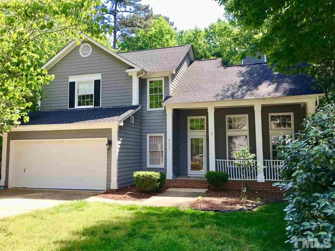 5217 Blakeley Lane Raleigh, NC 27613 - Photo 1 of 14 a view of a brick house with a yard plants and a large tree