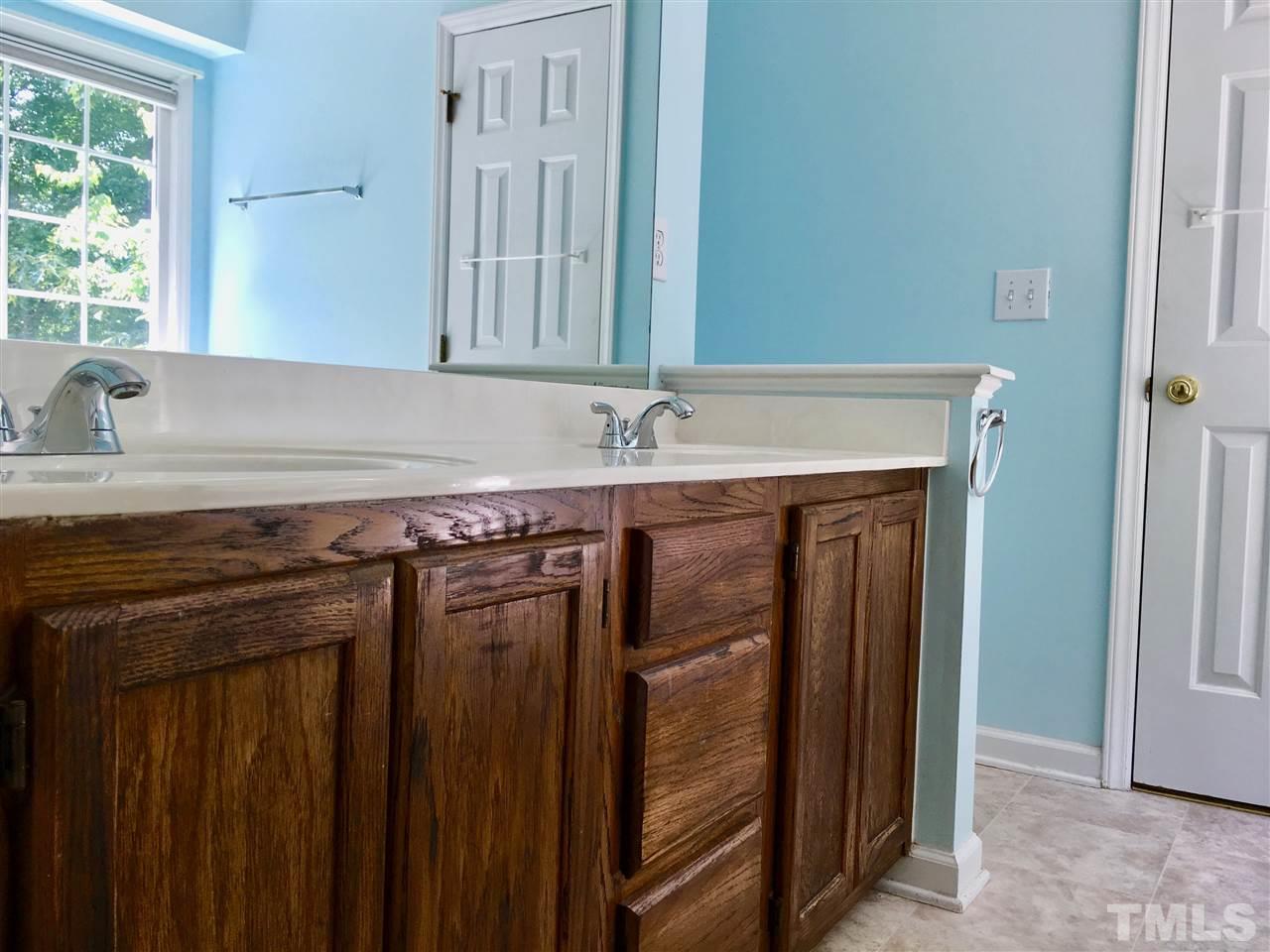 5217 Blakeley Lane Raleigh, NC 27613 - Photo 13 of 14 a bathroom with a granite countertop sink and a mirror