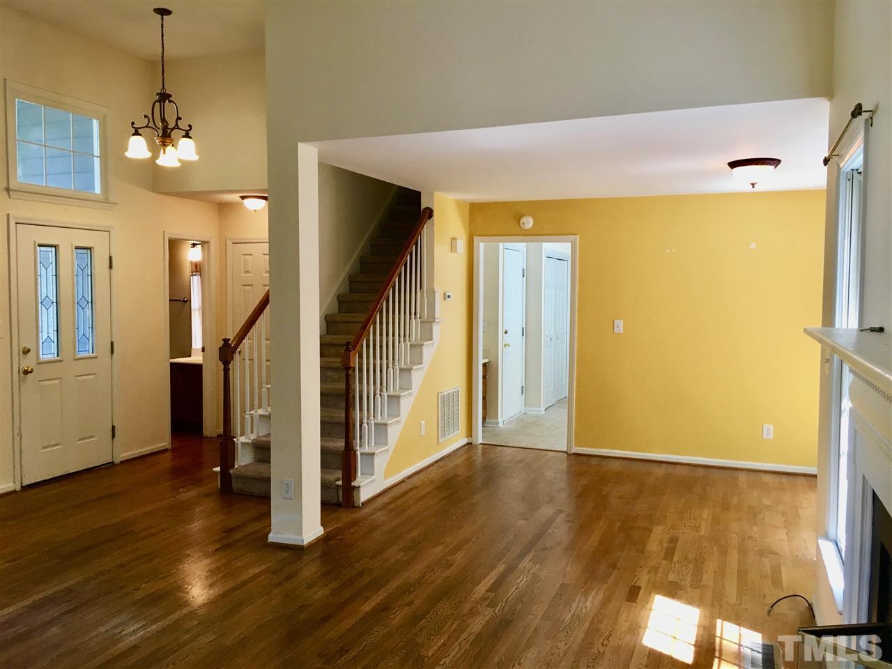 5217 Blakeley Lane Raleigh, NC 27613 - Photo 6 of 14 a view of a livingroom with wooden floor and stairs