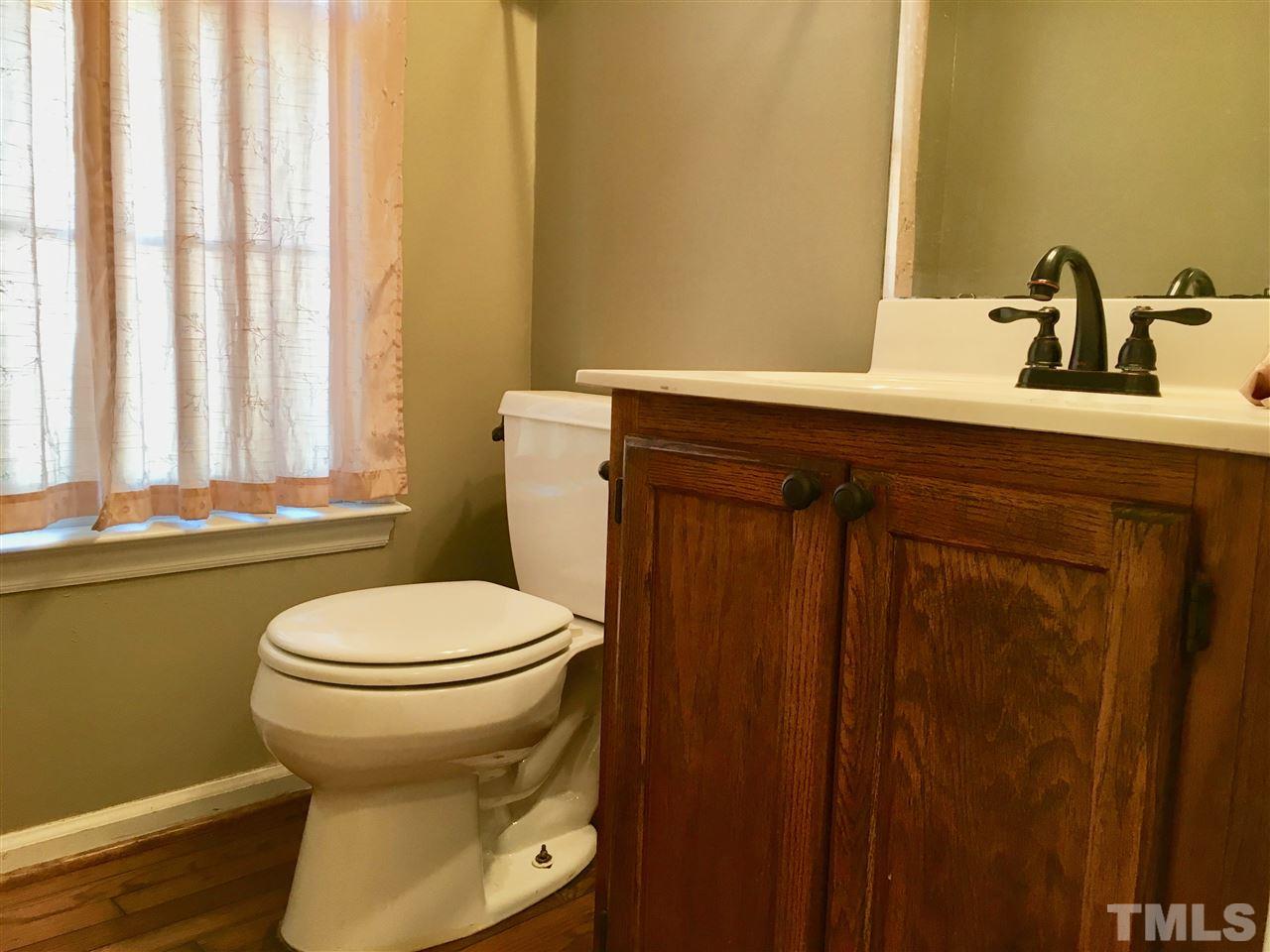 5217 Blakeley Lane Raleigh, NC 27613 - Photo 9 of 14 a bathroom with a toilet sink and mirror