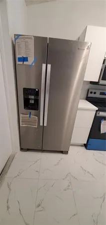 a view of washer and dryer with wooden floor