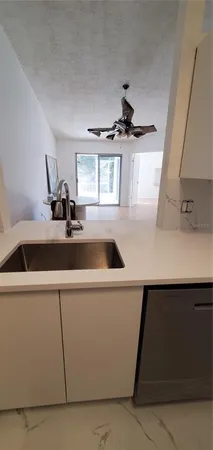 a kitchen with a sink and a refrigerator