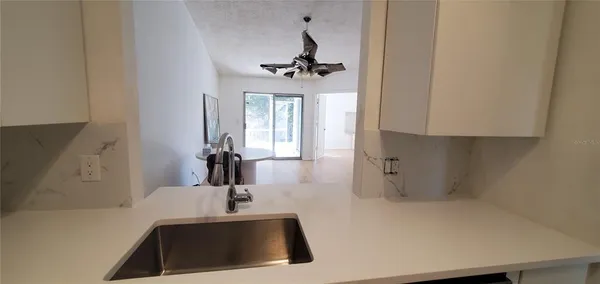 a kitchen with a sink and chandelier