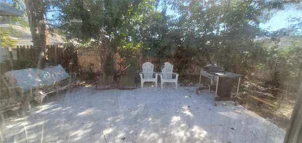 a view of a backyard with table and chairs