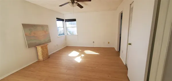 an empty room with windows and closet