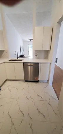 a view of kitchen with stainless steel appliances cabinets and a sink