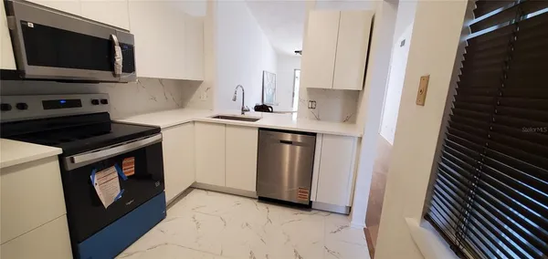 a kitchen with a sink and a stove top oven