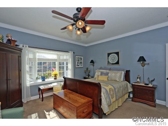 39 Hunters Trace Clyde, NC 28721 - Photo 11 of 18 a bedroom with a bed and a chandelier