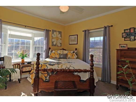 39 Hunters Trace Clyde, NC 28721 - Photo 13 of 18 a bed room with a bed window and table