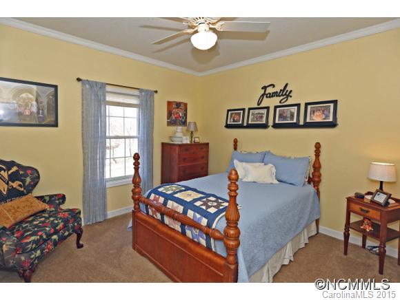 39 Hunters Trace Clyde, NC 28721 - Photo 14 of 18 a bedroom with a bed and furniture