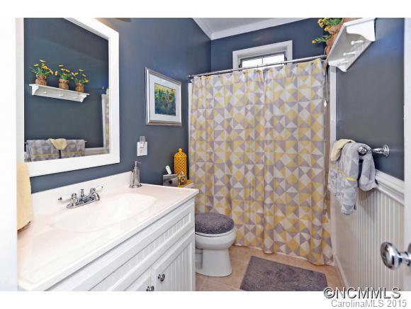 39 Hunters Trace Clyde, NC 28721 - Photo 15 of 18 a bathroom with a sink a toilet and a shower curtain