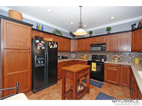 39 Hunters Trace Clyde, NC 28721 - Photo 8 of 18 a kitchen with stainless steel appliances granite countertop a refrigerator a sink and a stove
