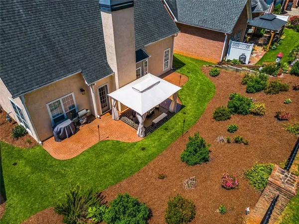 a view of a swimming pool with lawn chairs under an umbrella