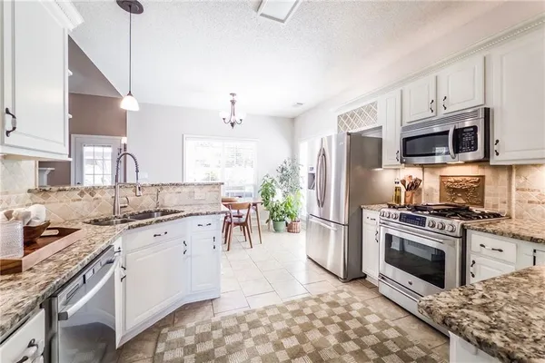 a kitchen with a sink stove and refrigerator