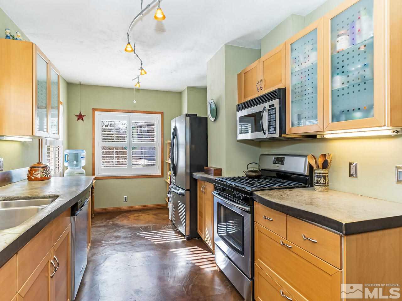 885 La Rue Avenue Reno, NV 89509 - Photo 6 of 18 a kitchen with stainless steel appliances granite countertop a stove a sink and a refrigerator