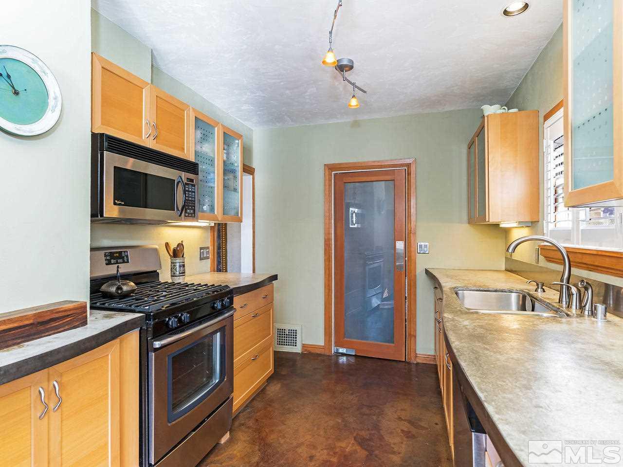885 La Rue Avenue Reno, NV 89509 - Photo 7 of 18 a kitchen with granite countertop a stove and a sink