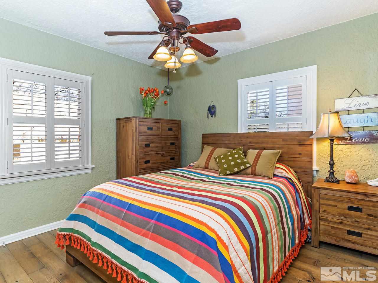 885 La Rue Avenue Reno, NV 89509 - Photo 8 of 18 a bedroom with a bed and a chandelier