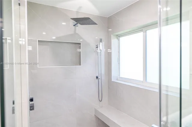 a bathroom with a bathtub and a shower