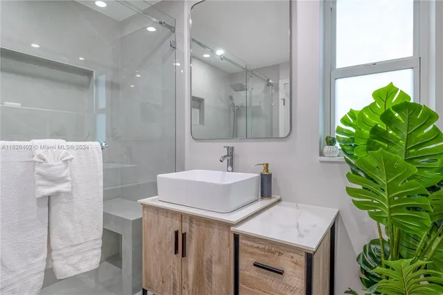 a bathroom with a sink a vanity and a mirror