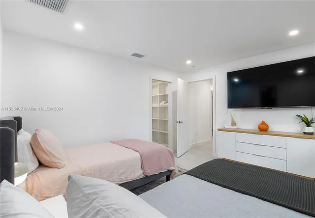 a bedroom with bed and tv