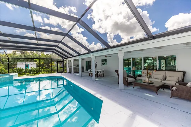 a swimming pool with outdoor seating and yard