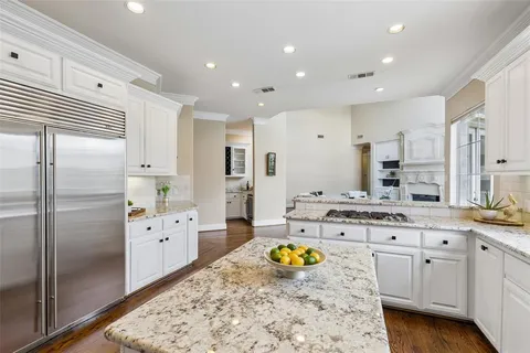 a kitchen with lot of cabinets and refrigerator