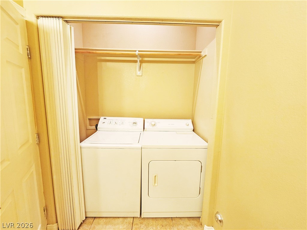 1421 Star Road, Unit 2 Pahrump, NV 89048 - Photo 12 of 33 Laundry room featuring laundry area, light tile patterned floors, and washing machine and clothes dryer