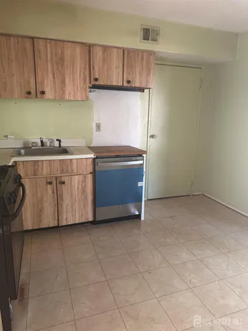 a kitchen with a cabinets and window