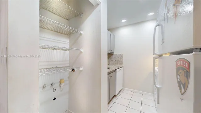 a living room with couches and kitchen view with wooden floor