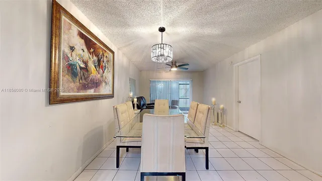 a view of a dining room with furniture and a chandelier
