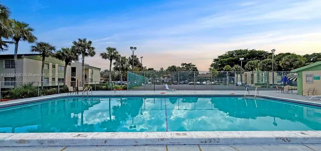 a bathroom with a toilet sink vanity and mirror