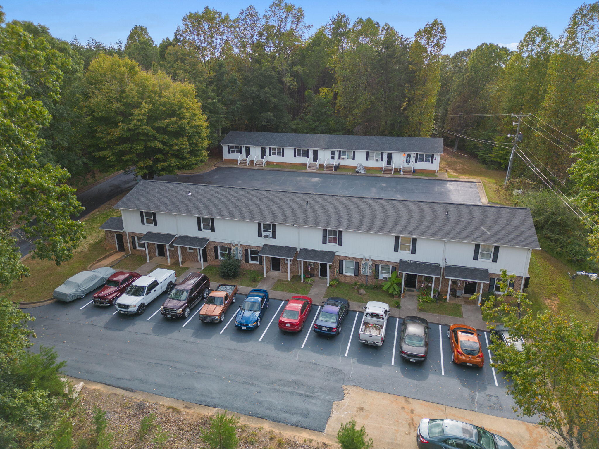 an aerial view of a building with cars parked
