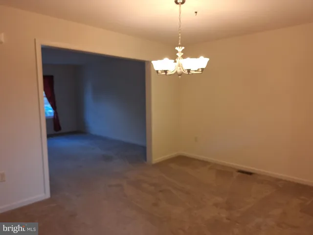 a view of a chandelier fan and entryway