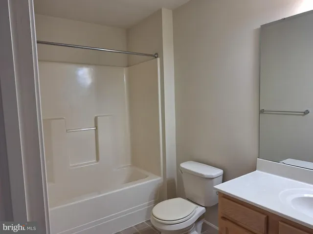 a white toilet sitting next to a bath tub