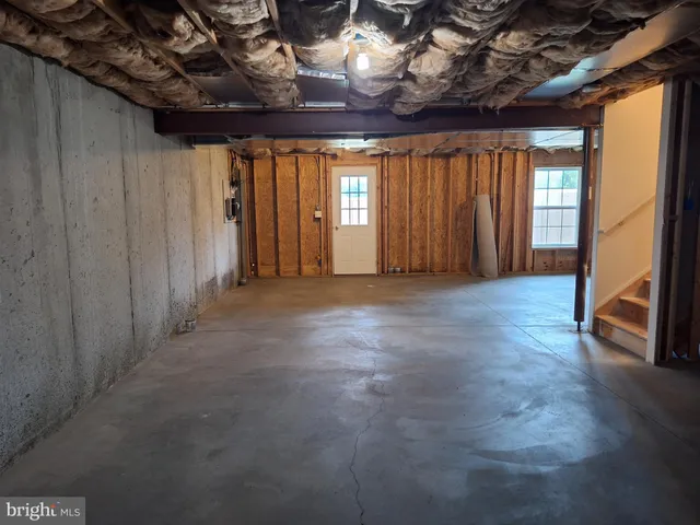 a view of a livingroom with an empty space and a window