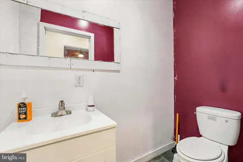a bathroom with a sink a toilet and mirror