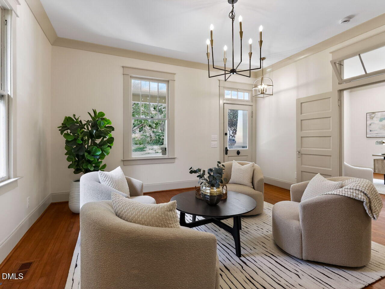 504 Tilden Street Raleigh, NC 27605 - Photo 18 of 58 a living room with furniture a chandelier and a window