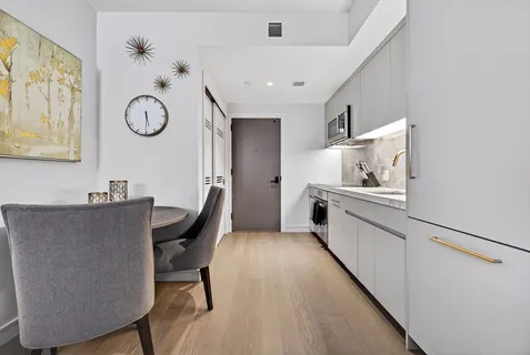 a kitchen with stainless steel appliances a sink and a refrigerator